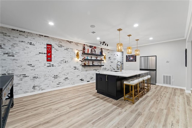 kitchen featuring stainless steel fridge, ornamental molding, baseboards, dark cabinets, and recessed lighting