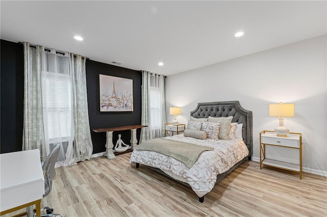 bedroom with light wood-style floors, baseboards, and recessed lighting