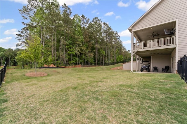 view of yard featuring a ceiling fan, a patio, and a wooden deck
