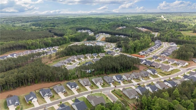 aerial view of property's location with a heavily wooded area and nearby suburban area