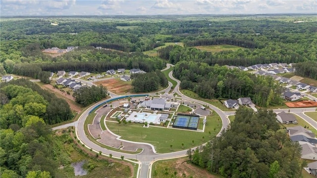 aerial overview of property's location with a forest and nearby suburban area