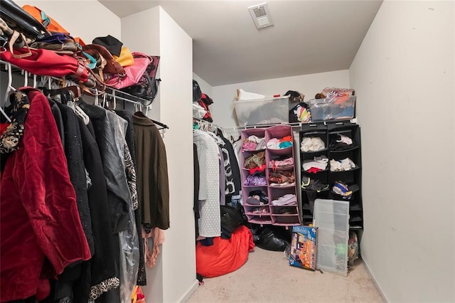 walk in closet featuring visible vents and carpet flooring