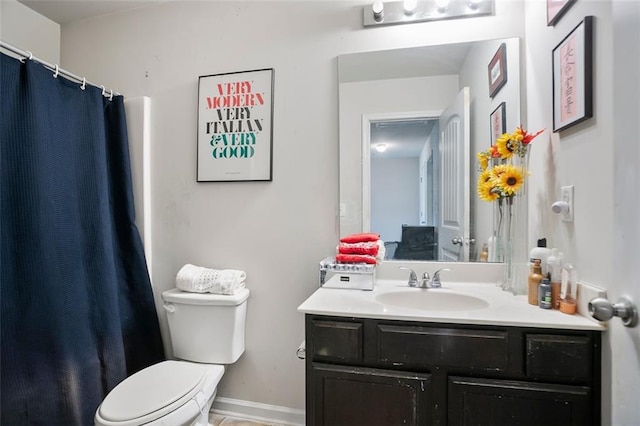 bathroom featuring a shower with curtain, vanity, toilet, and baseboards