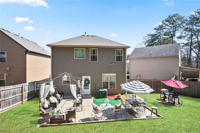 back of house featuring central air condition unit, a patio area, a fenced backyard, and a yard