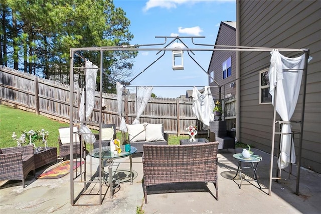 view of patio featuring fence and an outdoor living space