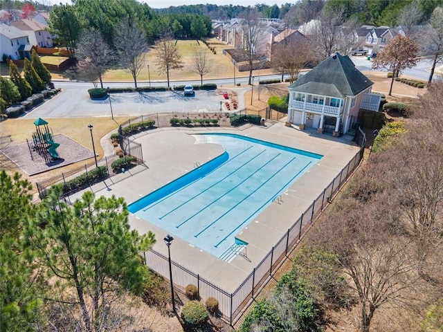 view of swimming pool featuring fence