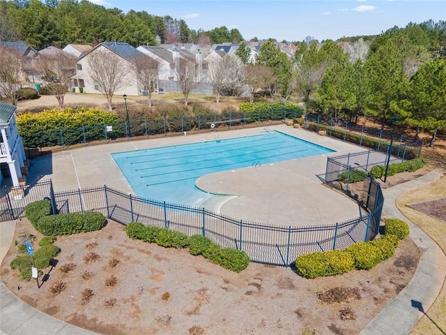 community pool featuring fence and a patio