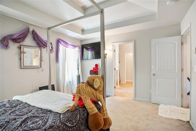 bedroom featuring baseboards, a tray ceiling, and carpet flooring