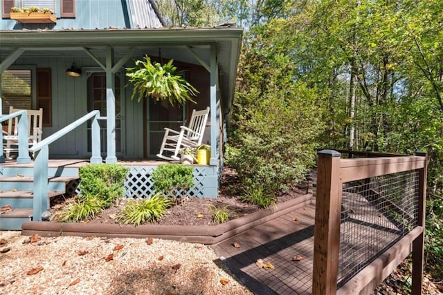 view of side of home with covered porch