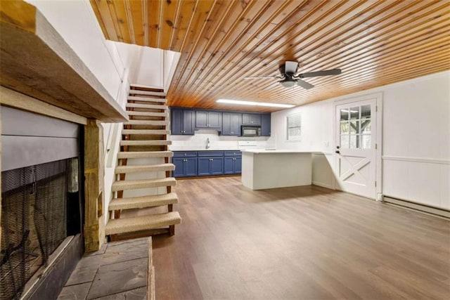 kitchen featuring ceiling fan, blue cabinets, wood ceiling, and light wood-type flooring