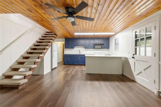 kitchen featuring sink, blue cabinets, wood-type flooring, white appliances, and wood ceiling