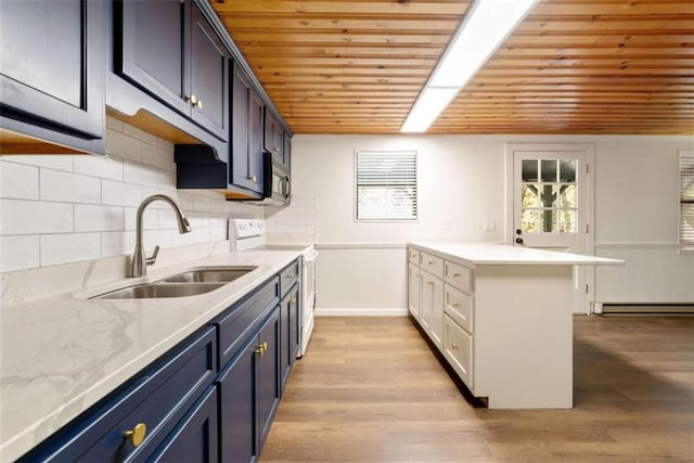 kitchen featuring blue cabinetry, sink, range with electric cooktop, and light hardwood / wood-style flooring