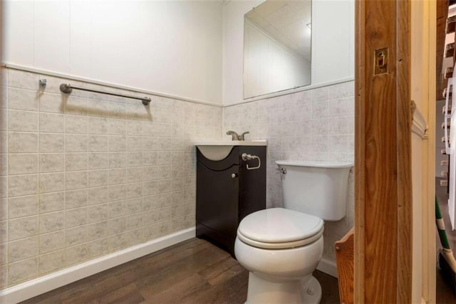 bathroom featuring hardwood / wood-style floors, vanity, toilet, and tile walls