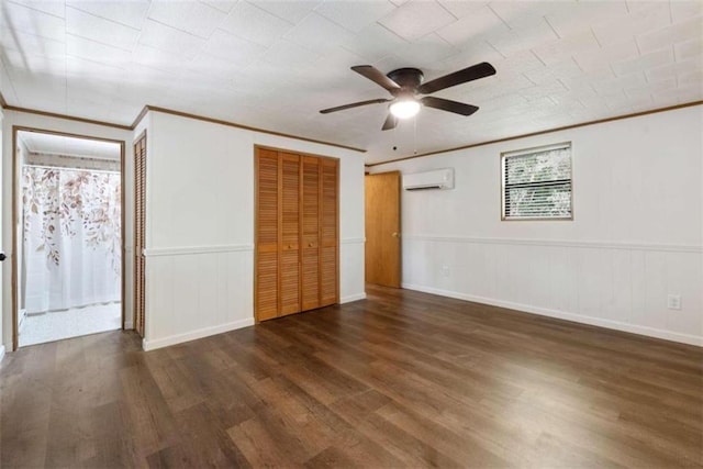 unfurnished bedroom featuring ceiling fan, a wall mounted air conditioner, dark hardwood / wood-style floors, and ornamental molding