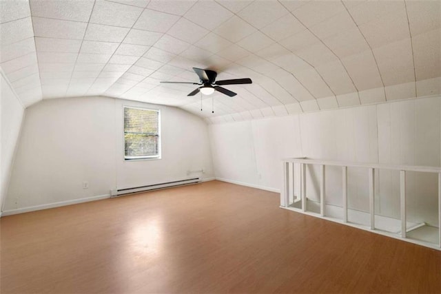 additional living space featuring ceiling fan, a baseboard radiator, vaulted ceiling, and wood-type flooring