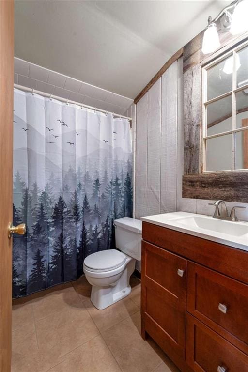 bathroom featuring tile patterned flooring, vanity, and toilet