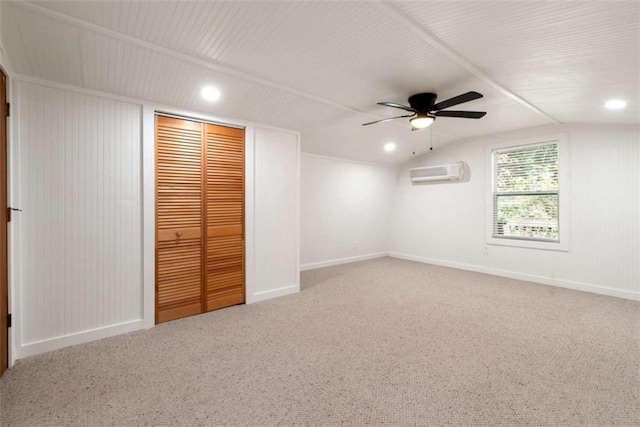 unfurnished bedroom featuring carpet, a wall mounted AC, ceiling fan, a closet, and lofted ceiling