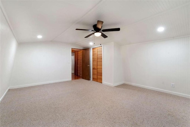 unfurnished room with ceiling fan, carpet floors, and lofted ceiling