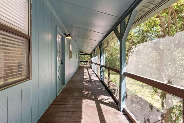 unfurnished sunroom featuring lofted ceiling