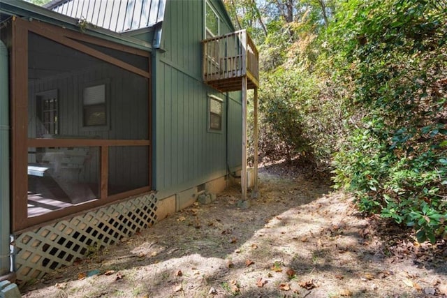 view of side of property with a balcony