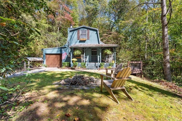 exterior space featuring covered porch, a garage, and a front yard