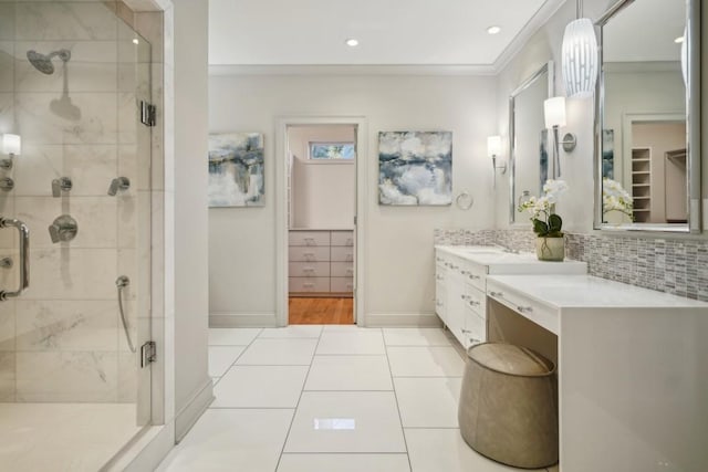 bathroom with vanity, a shower with door, tile patterned flooring, ornamental molding, and tasteful backsplash