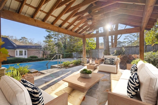 view of patio with a gazebo, ceiling fan, outdoor lounge area, and a covered pool