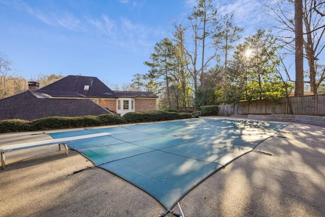 view of pool featuring a diving board and a patio area