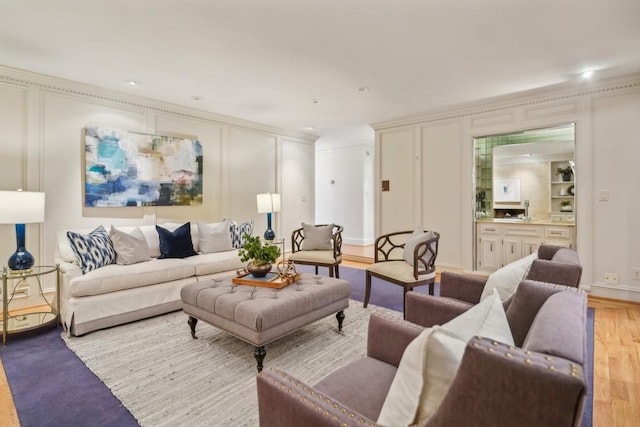 living room featuring light wood-type flooring and crown molding