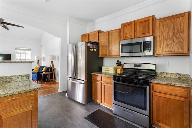 747 Dill Ave SW, Atlanta, GA 30310 - kitchen featuring stainless steel appliances, a ceiling fan, ornamental molding, light stone countertops, and brown cabinetry