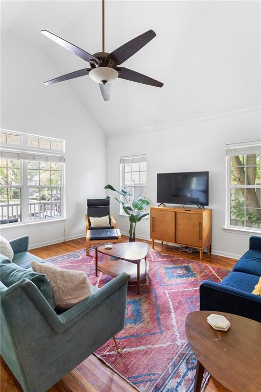 747 Dill Ave SW, Atlanta, GA 30310 - living area featuring high vaulted ceiling, a ceiling fan, wood finished floors, and baseboards
