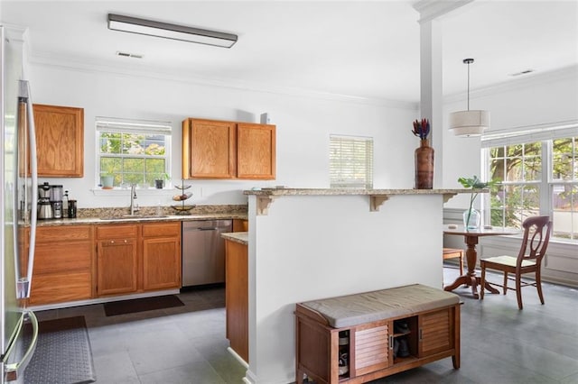 747 Dill Ave SW, Atlanta, GA 30310 - kitchen with stainless steel appliances, a sink, a kitchen breakfast bar, ornamental molding, and brown cabinets