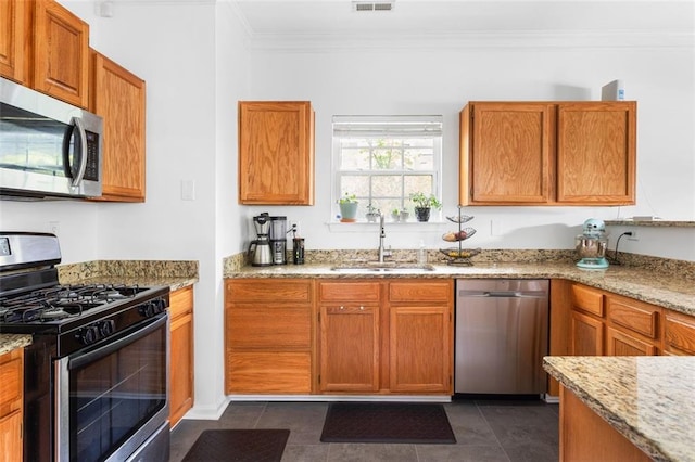 747 Dill Ave SW, Atlanta, GA 30310 - kitchen with appliances with stainless steel finishes, a sink, ornamental molding, light stone countertops, and brown cabinetry