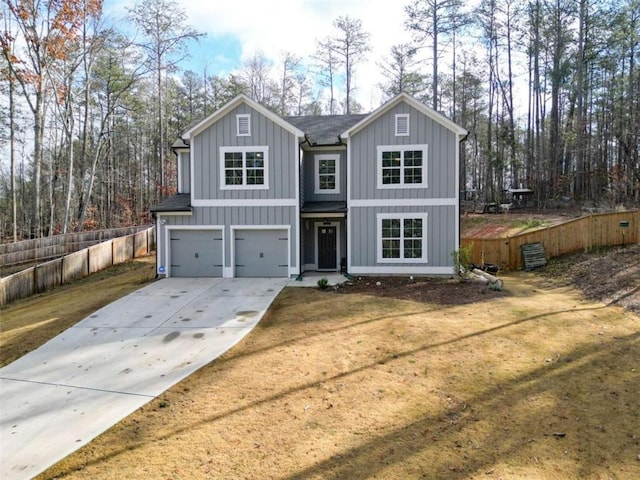 view of front of property with a front lawn and a garage