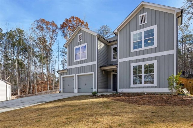 view of front of home with a front yard and a garage