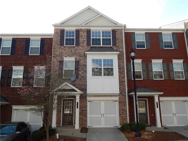 2199 Landing Walk Dr, Duluth, GA 30097 - view of property with brick siding, a garage, and driveway