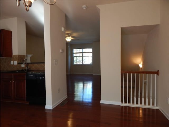 2199 Landing Walk Dr, Duluth, GA 30097 - kitchen with dishwasher, dark wood-style flooring, a ceiling fan, tasteful backsplash, and a chandelier