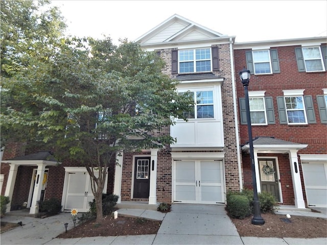 2199 Landing Walk Dr, Duluth, GA 30097 - townhome / multi-family property featuring brick siding, driveway, and an attached garage