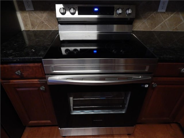 2199 Landing Walk Dr, Duluth, GA 30097 - kitchen view of stainless steel range with electric cooktop, tasteful backsplash, and wood finished floors