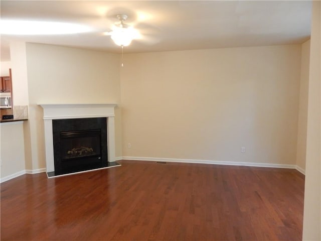 2199 Landing Walk Dr, Duluth, GA 30097 - unfurnished living room featuring ceiling fan, dark wood-style flooring, and a glass covered fireplace