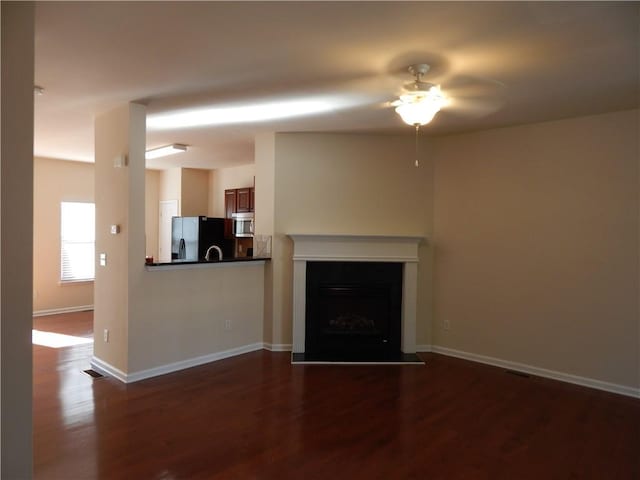 2199 Landing Walk Dr, Duluth, GA 30097 - unfurnished living room featuring a ceiling fan, dark wood-style floors, and a fireplace with flush hearth