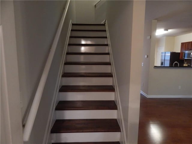 2199 Landing Walk Dr, Duluth, GA 30097 - stairway featuring wood finished floors and baseboards