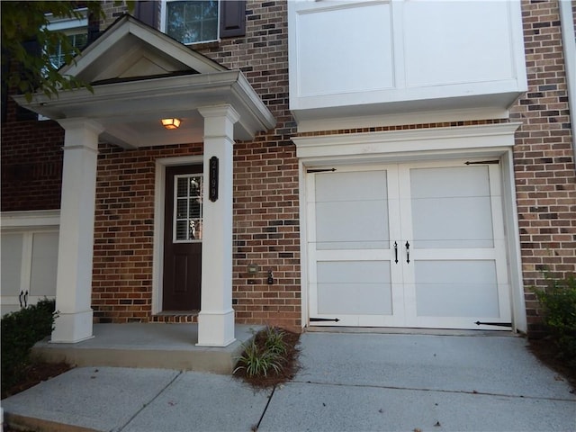 2199 Landing Walk Dr, Duluth, GA 30097 - property entrance featuring brick siding, an attached garage, and concrete driveway