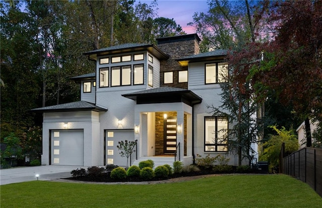 view of front of property featuring a garage and a yard