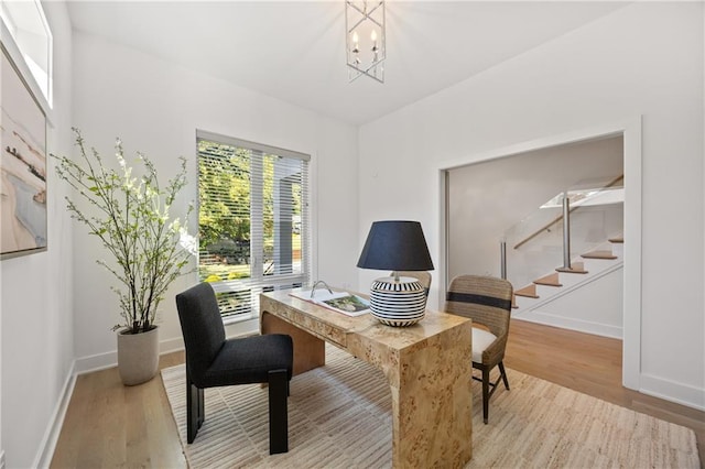 office area featuring light hardwood / wood-style flooring and an inviting chandelier