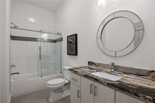 full bathroom featuring bath / shower combo with glass door, toilet, and vanity