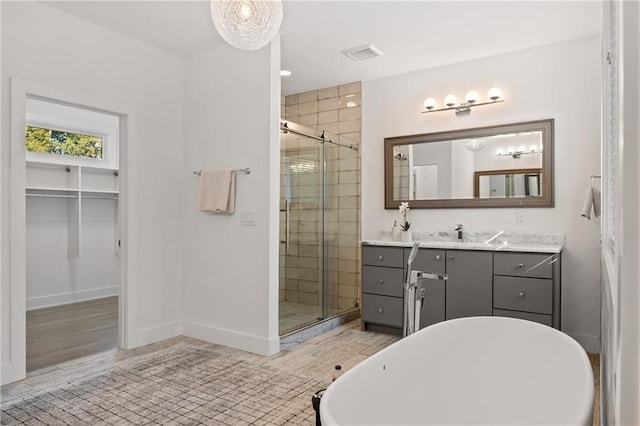 bathroom featuring separate shower and tub and vanity