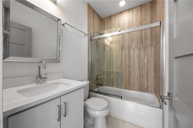 full bathroom featuring toilet, tile patterned flooring, shower / bath combination with glass door, and vanity