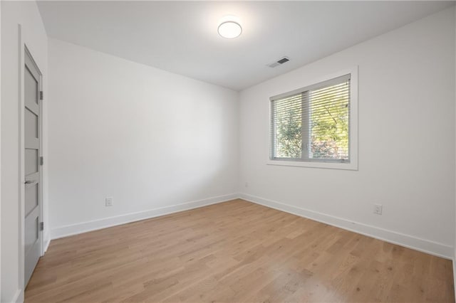 unfurnished room with light wood-type flooring