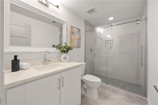 bathroom featuring vanity, toilet, and walk in shower